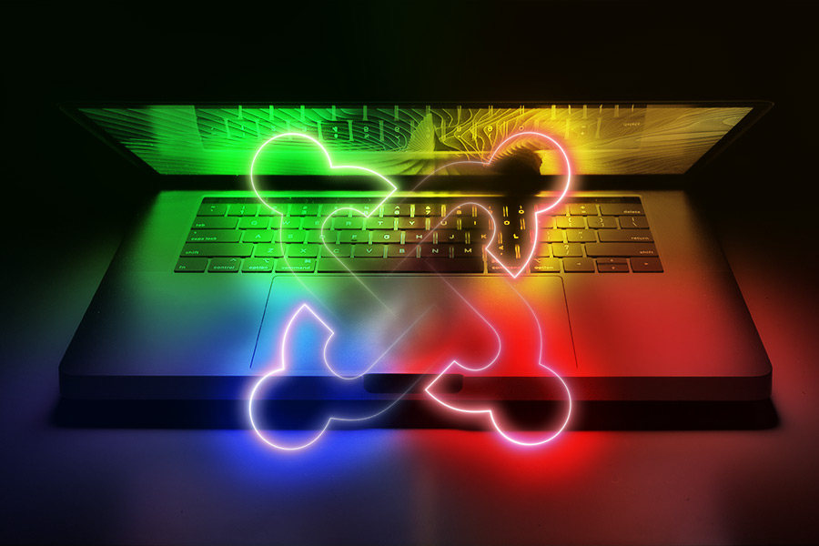 Joomla logo emerging from a half-open laptop